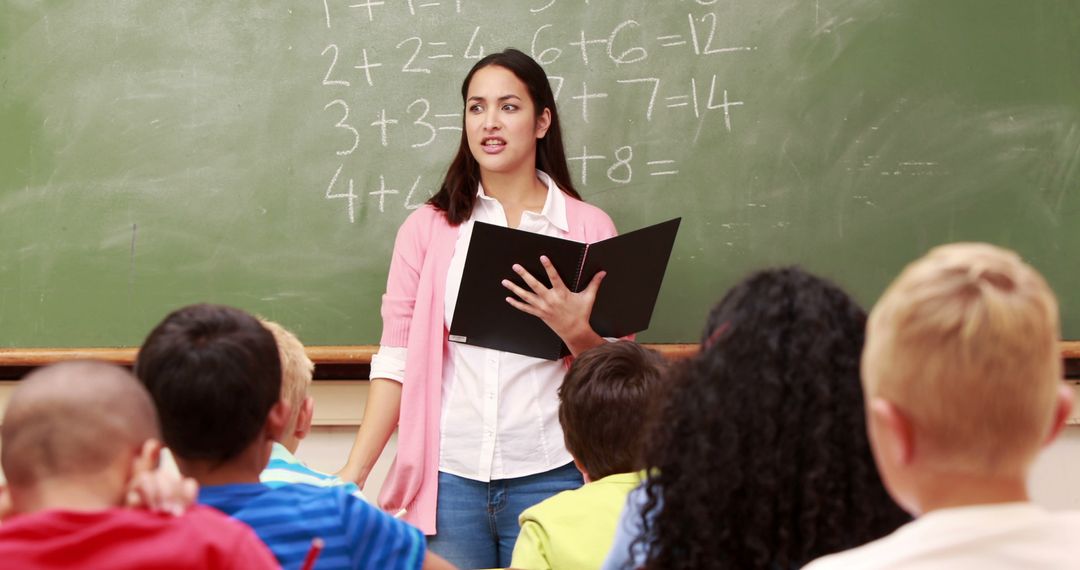 Female Teacher Instructing Diverse Elementary Students In Classroom - Free Images, Stock Photos and Pictures on Pikwizard.com