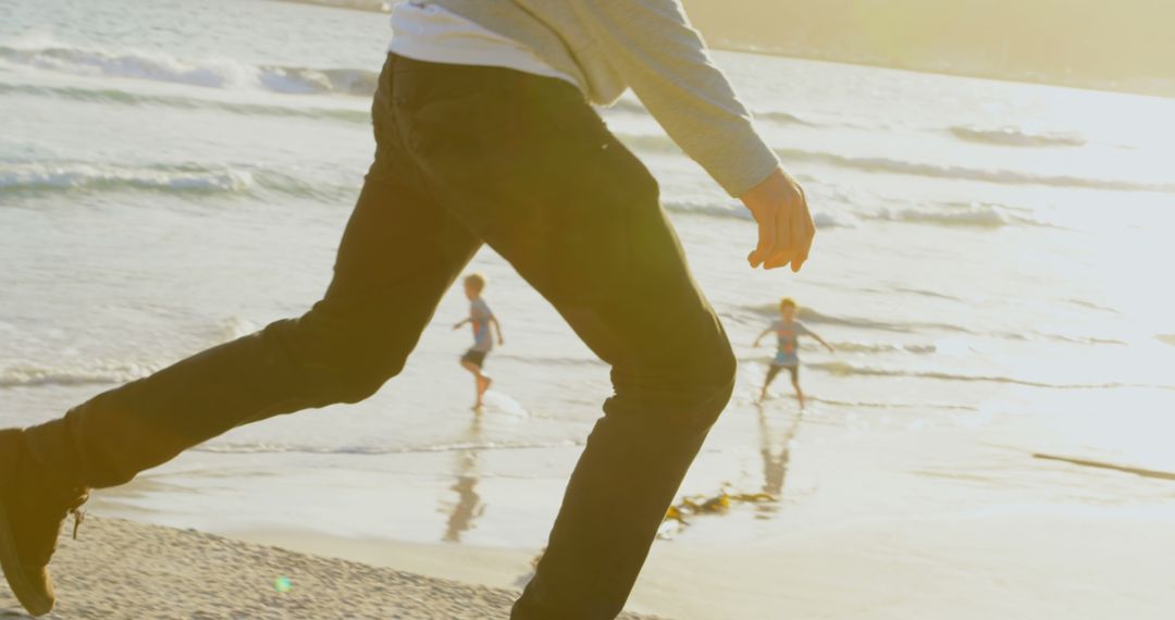 Person Running on Beach with Children Playing in Background - Free Images, Stock Photos and Pictures on Pikwizard.com