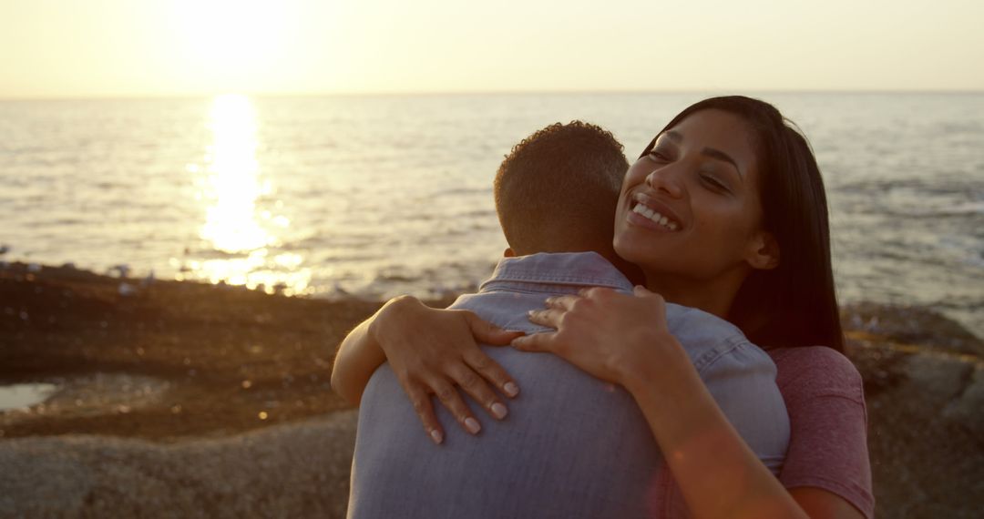 Happy Couple Embracing at Sunset Near Ocean - Free Images, Stock Photos and Pictures on Pikwizard.com