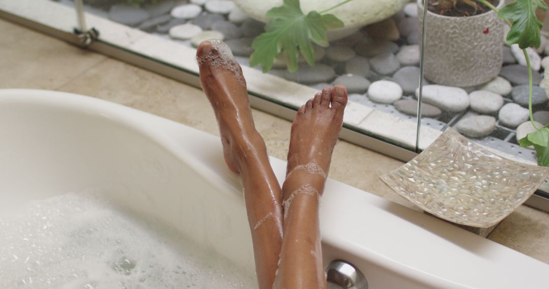 Biracial woman lying in a bathtub at home - Free Images, Stock Photos and Pictures on Pikwizard.com