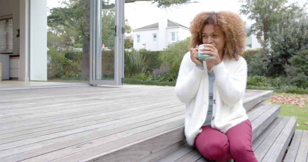 Woman Enjoying Hot Beverage on Patio Steps - Free Images, Stock Photos and Pictures on Pikwizard.com