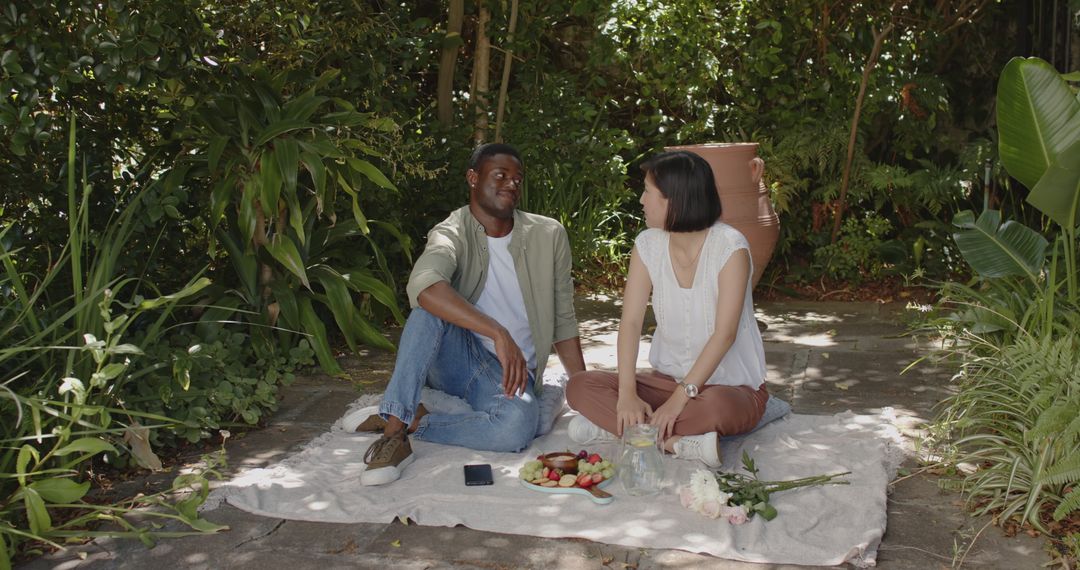 Romantic Couple Enjoying Picnic in Tranquil Garden Environment