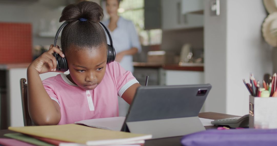 African American Girl Studying Online at Home on Tablet Wearing Headphones - Free Images, Stock Photos and Pictures on Pikwizard.com