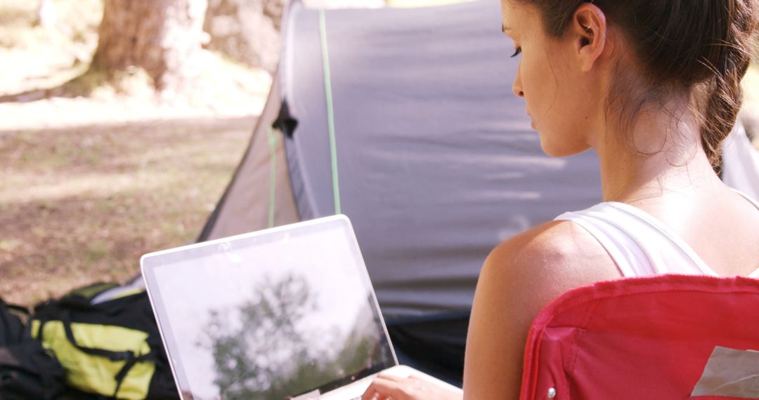 Woman Working on Laptop in Outdoor Camping Scene - Free Images, Stock Photos and Pictures on Pikwizard.com