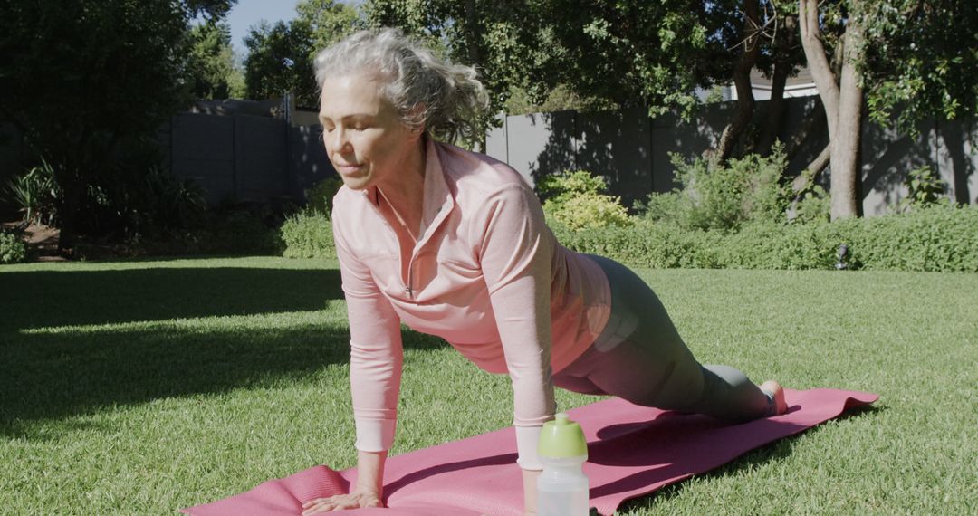 Senior Woman Practicing Yoga Outdoors on Sunny Day - Free Images, Stock Photos and Pictures on Pikwizard.com