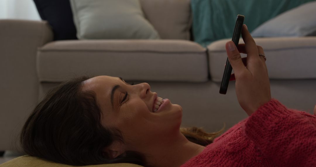 Woman Relaxing at Home Smiling While Texting on Smartphone - Free Images, Stock Photos and Pictures on Pikwizard.com