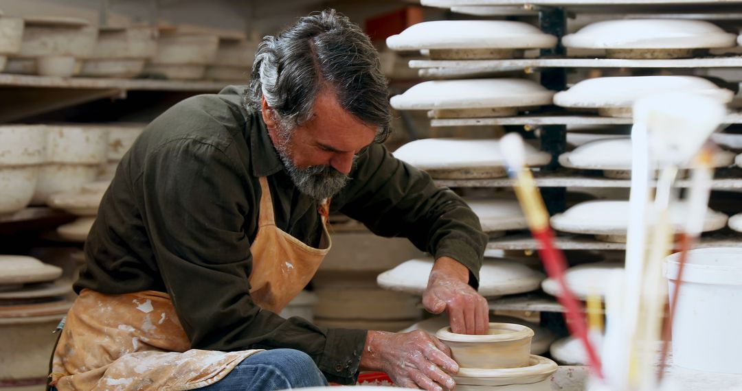 Skilled Potter Shaping Clay on Pottery Wheel in Workshop - Free Images, Stock Photos and Pictures on Pikwizard.com