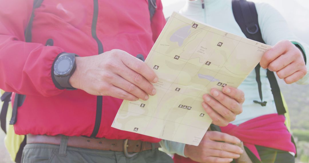 Senior Couple Navigating with Map During Mountain Hike