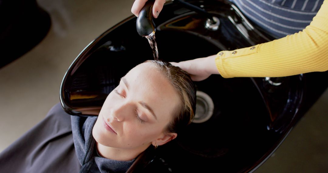 Woman Relaxing While Hairdresser Washing Hair in Salon - Free Images, Stock Photos and Pictures on Pikwizard.com