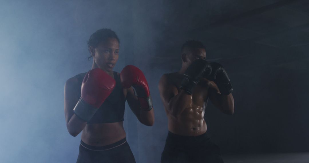 Focused Athletes Boxing in Smoky Gym - Free Images, Stock Photos and Pictures on Pikwizard.com