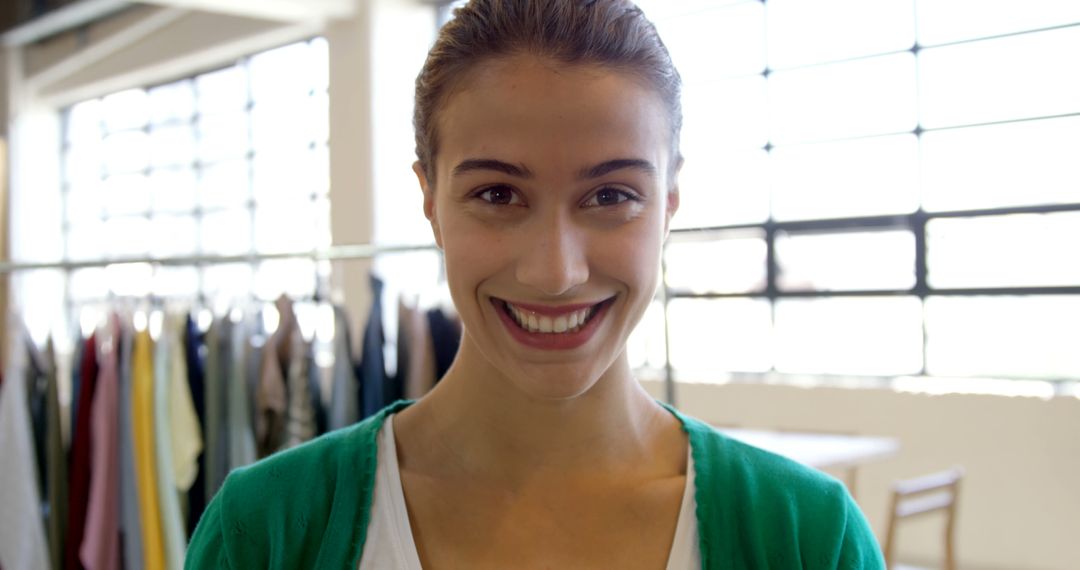 Smiling Woman Posing in Fashion Retail Store - Free Images, Stock Photos and Pictures on Pikwizard.com