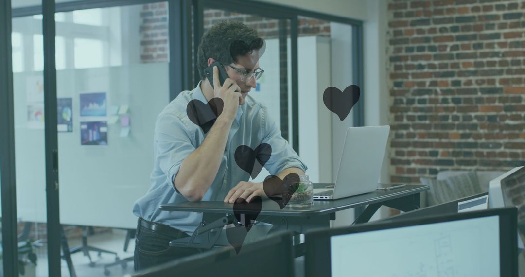 Businessman on Phone Call in Modern Office with Heart Graphics