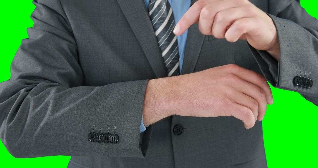 Businessman adjusting sleeve cuffs in suit and tie on green background - Free Images, Stock Photos and Pictures on Pikwizard.com