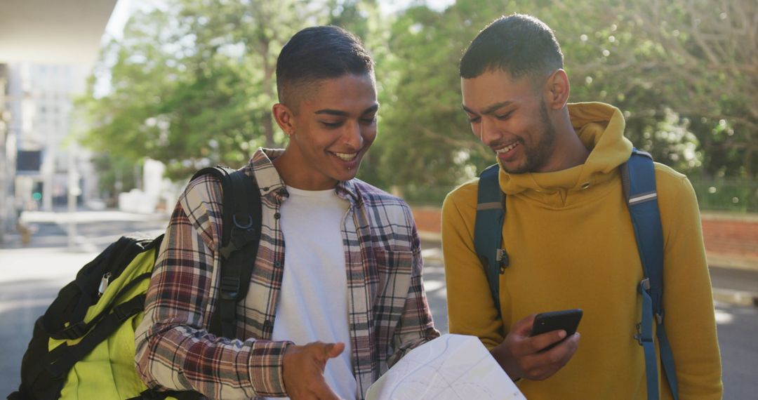 Two Friends Exploring Street with Smartphone and Map