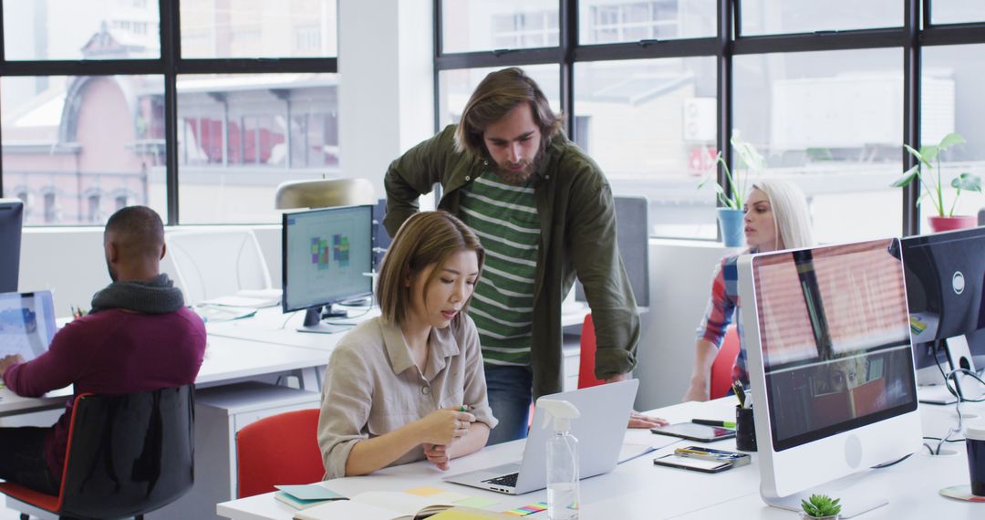 Diverse Colleagues Collaborating in Contemporary Office Environment