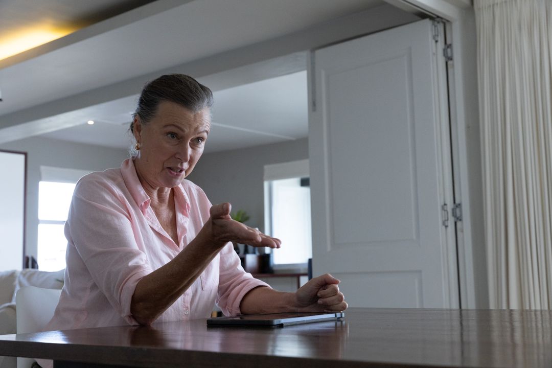 Senior Woman Using Tablet in Bright Lively Home Environment