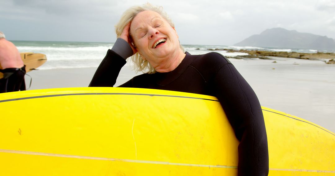 Elderly Surfer Enjoying at Beach with Yellow Surfboard - Free Images, Stock Photos and Pictures on Pikwizard.com