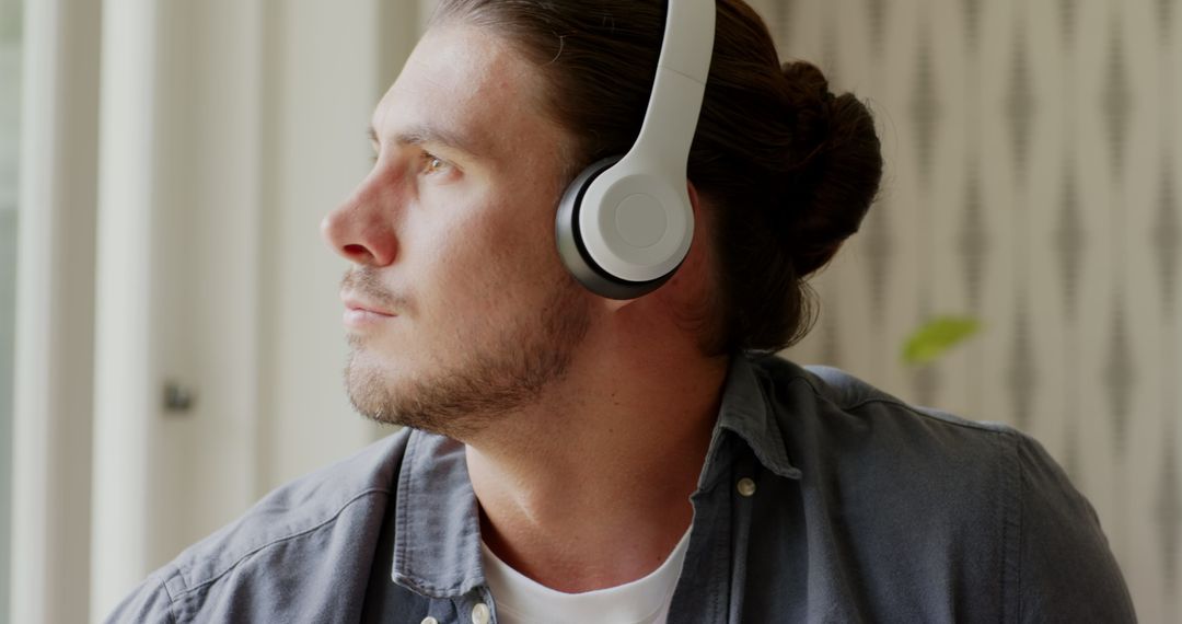 Man Enjoying Music and Using Smartwatch in Relaxing Environment