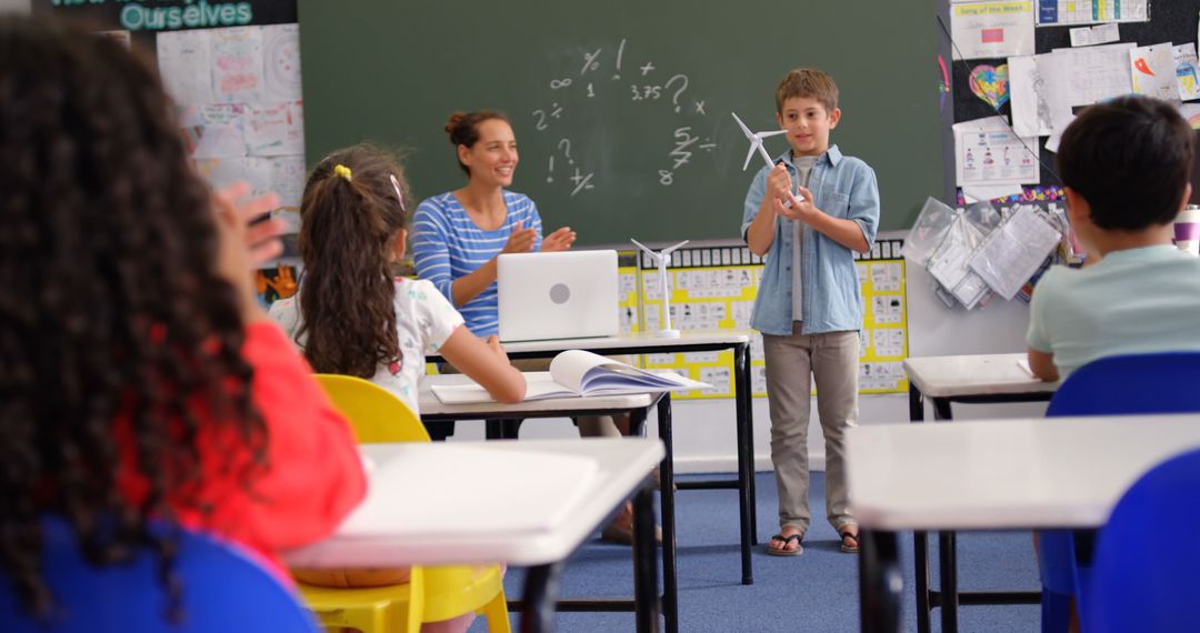Schoolboy Presenting Windmill Model in Classroom