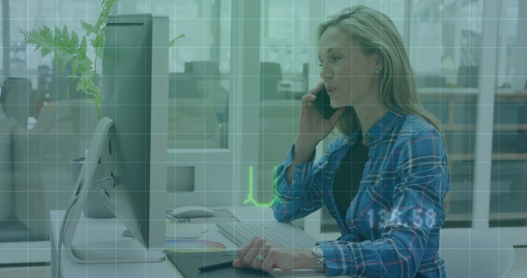 Businesswoman Using Computer with Financial Data Overlay in Office