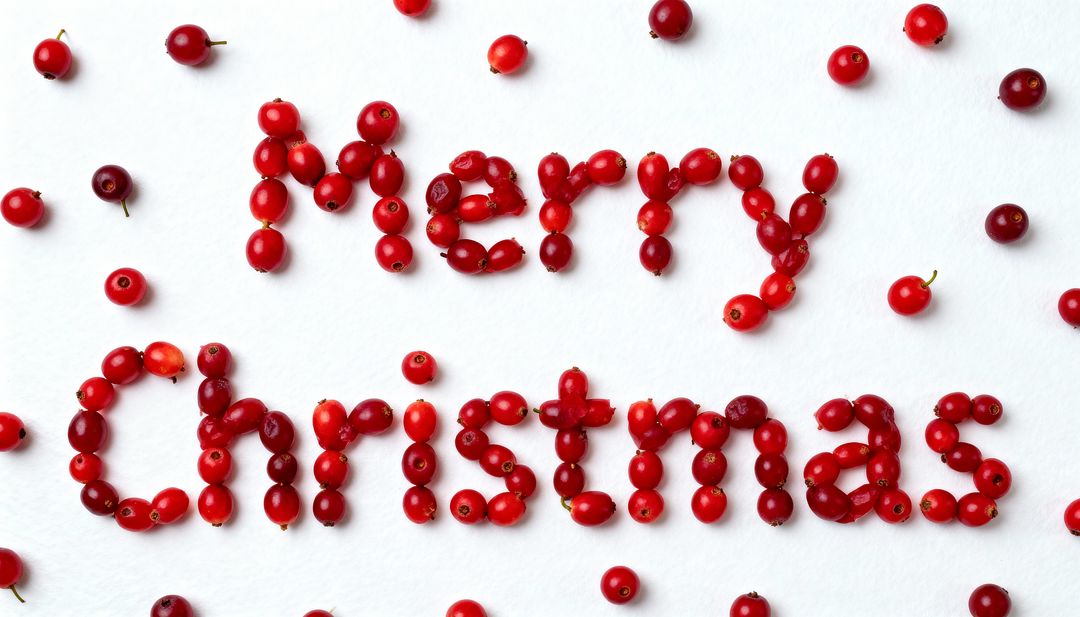Merry Christmas spelled with red cranberries on white textured background, flatlay, minimal