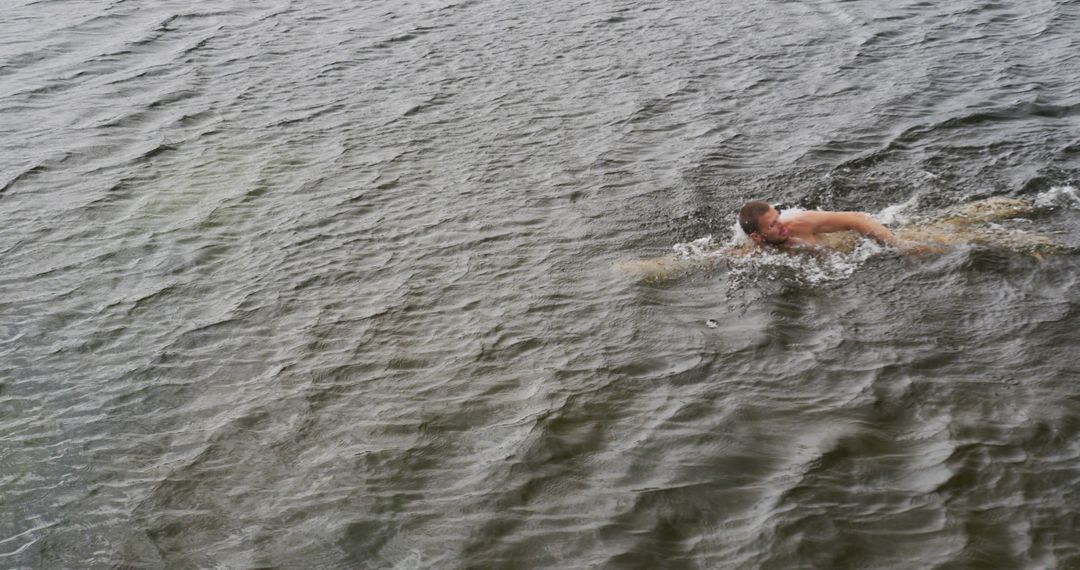 Man Swimming in Open Water during Grey Weather - Free Images, Stock Photos and Pictures on Pikwizard.com