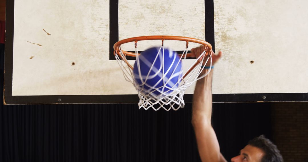 Basketball Player Performing Slam Dunk in Gym - Free Images, Stock Photos and Pictures on Pikwizard.com