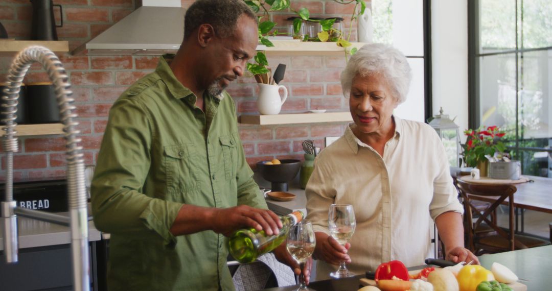 Senior Couple Enjoying Wine While Cooking in Modern Kitchen