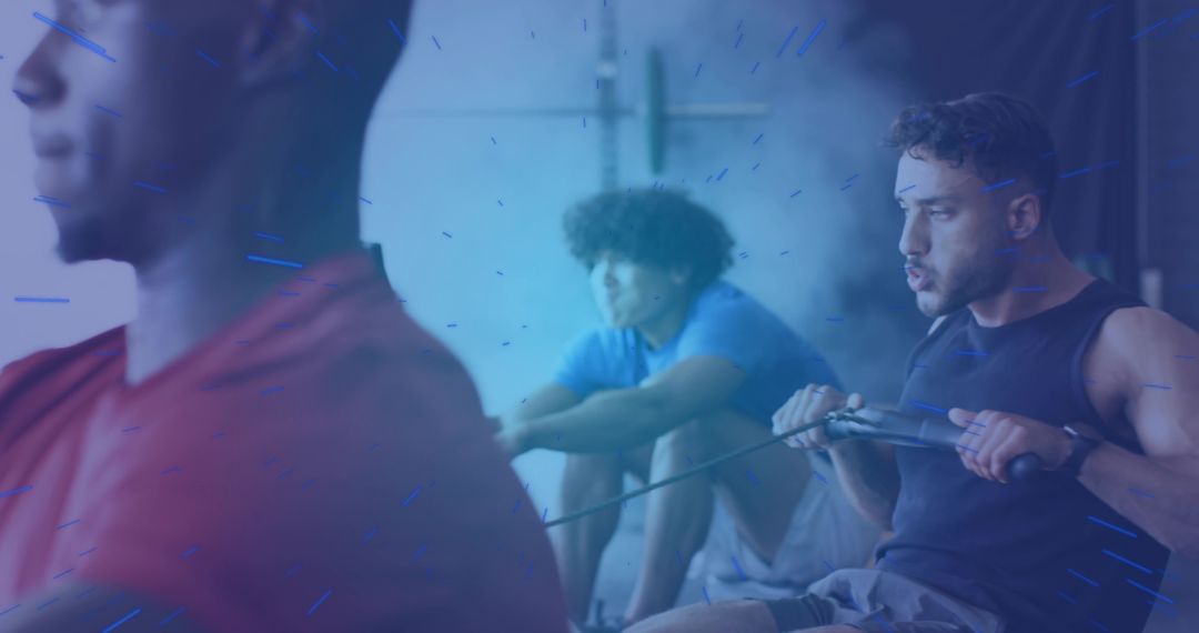 Group of Men Exercising on Rowing Machines in Modern Gym
