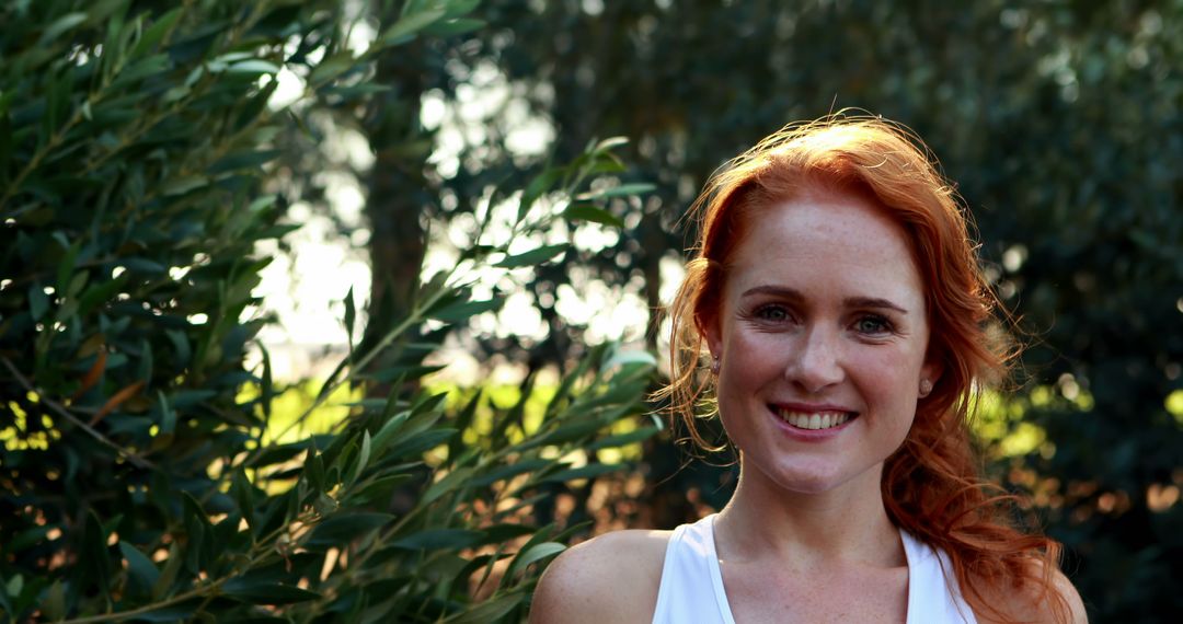 Smiling Woman with Red Hair Enjoying Nature Outdoors - Free Images, Stock Photos and Pictures on Pikwizard.com