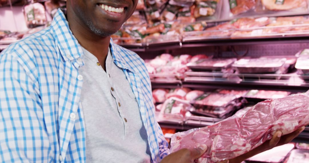 Middle-aged Man Holding Packaged Meat in Grocery Store - Free Images, Stock Photos and Pictures on Pikwizard.com