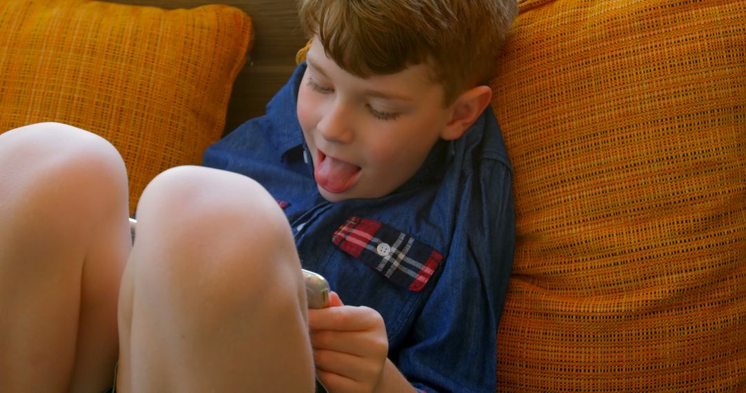 Boy Relaxing with Digital Tablet at Home