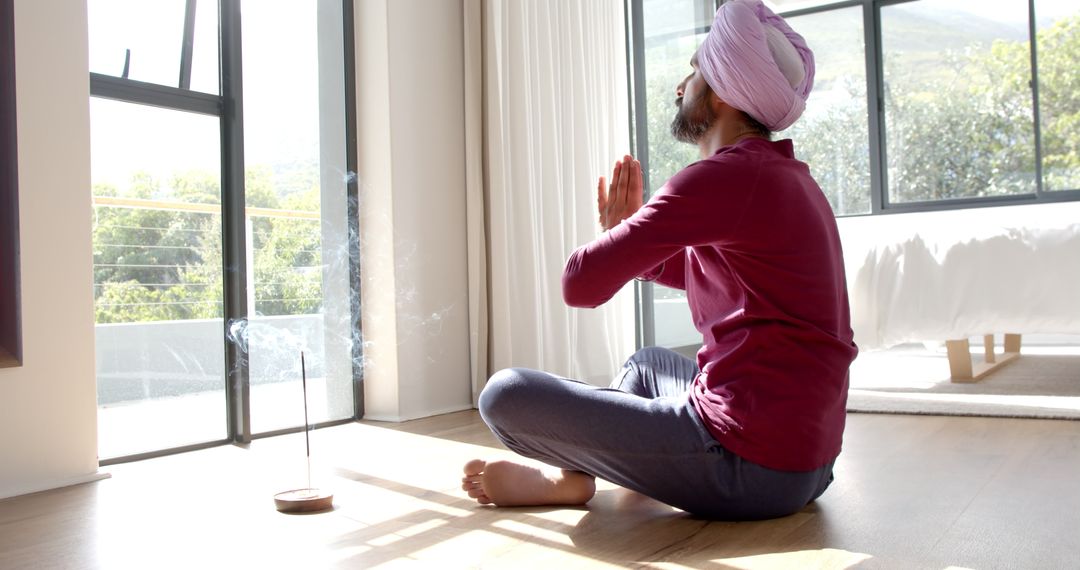 Man Meditating at Home with Incense for Peaceful Relaxation