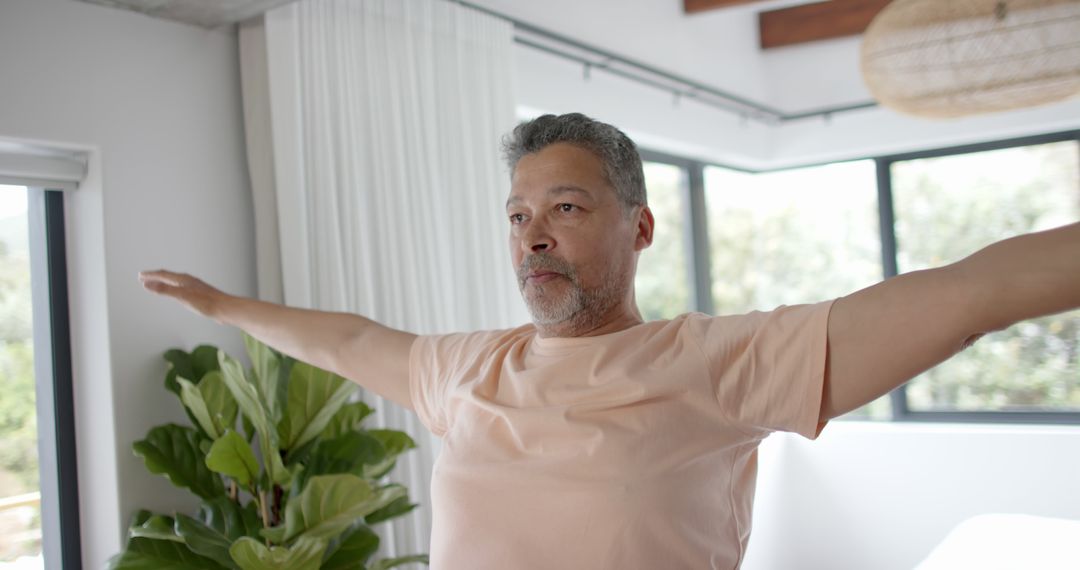 Man Practicing Yoga at Home in Bright Room - Free Images, Stock Photos and Pictures on Pikwizard.com