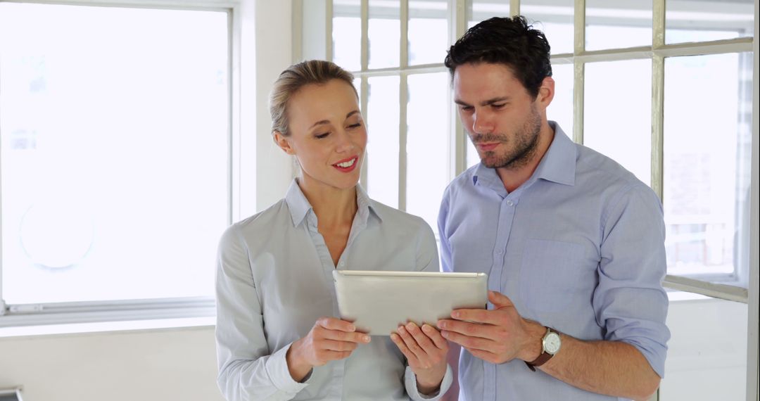 Business Colleagues Collaborating with a Digital Tablet in Office