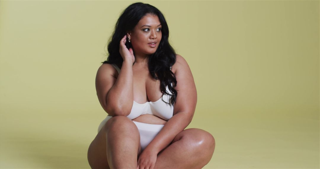 Confident Plus Size Woman Posing in Minimalistic Studio