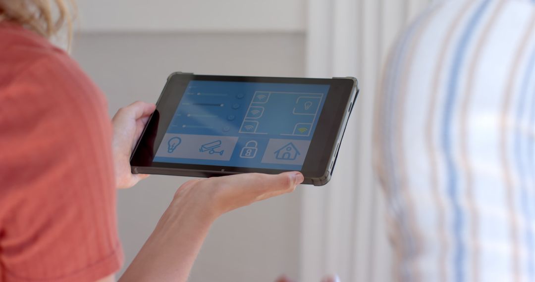 Couple Adjusting Smart Home System with Tablet near Window