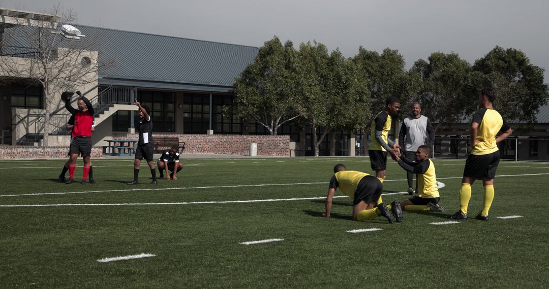 Soccer Team Practicing on Grass Field with Coach Guidance
