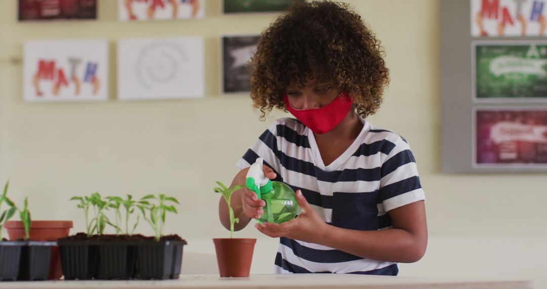 Child Caring for Plants in Classroom Wearing Mask - Free Images, Stock Photos and Pictures on Pikwizard.com