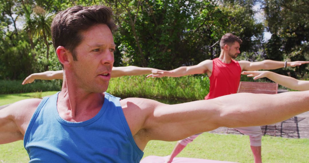 Group Yoga Session in Park Led by Male Instructor