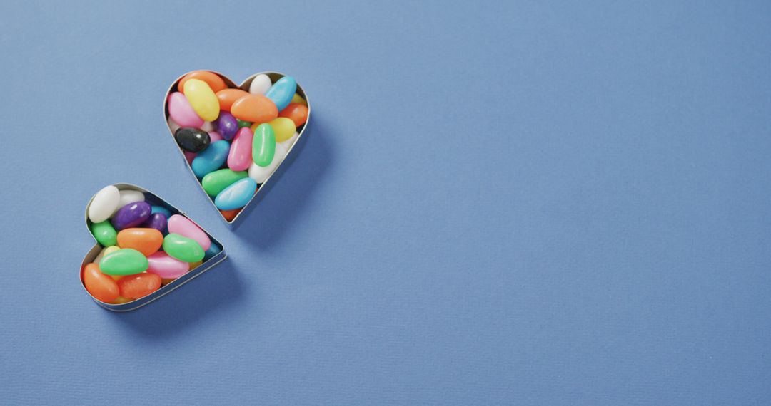 Colorful Jelly Beans in Heart Shaped Containers on Blue Background - Free Images, Stock Photos and Pictures on Pikwizard.com