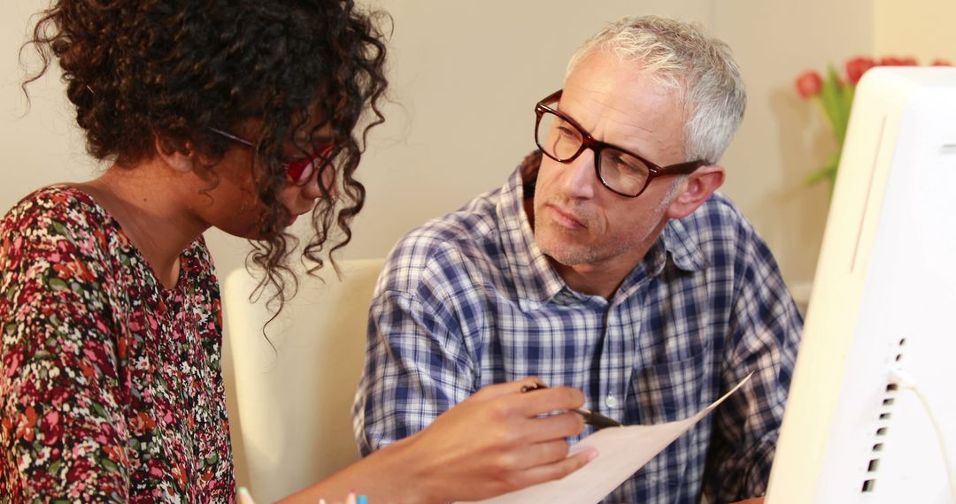 Diverse Professionals Collaborating on Document in Office