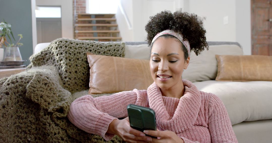 Smiling Woman Relaxing at Home Scrolling on Smartphone - Free Images, Stock Photos and Pictures on Pikwizard.com