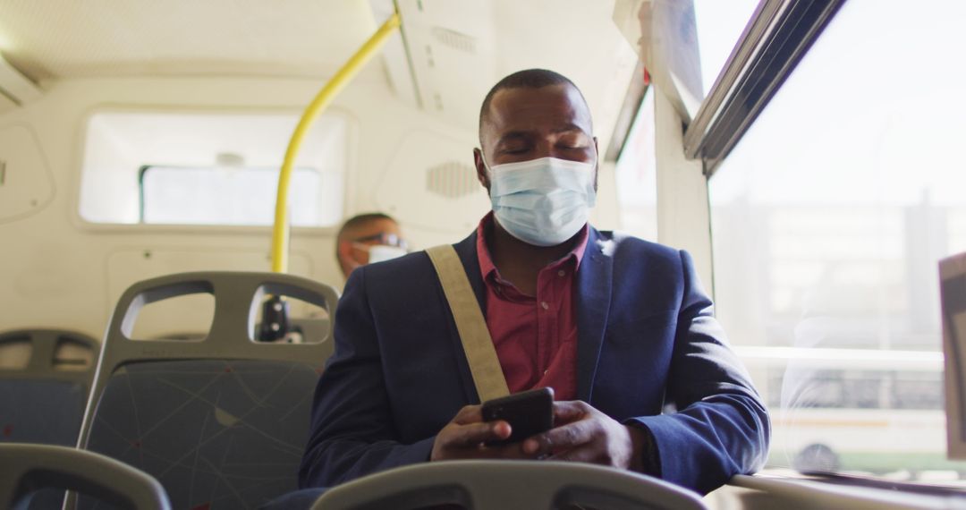 Urban Commuter Wearing Mask Using Smartphone Inside City Bus