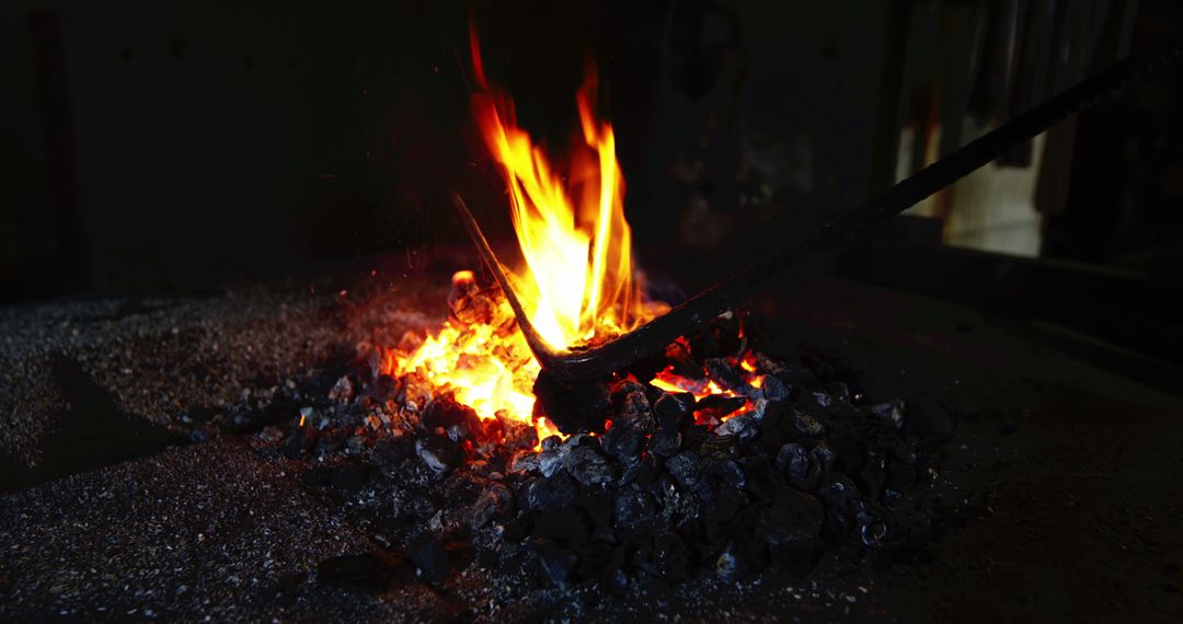 Blacksmith Stoking Flames in Rural Forge - Free Images, Stock Photos and Pictures on Pikwizard.com