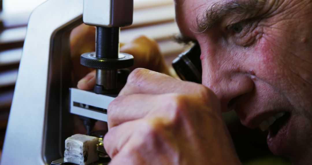 Senior Scientist Studying Sample Under Microscope - Free Images, Stock Photos and Pictures on Pikwizard.com