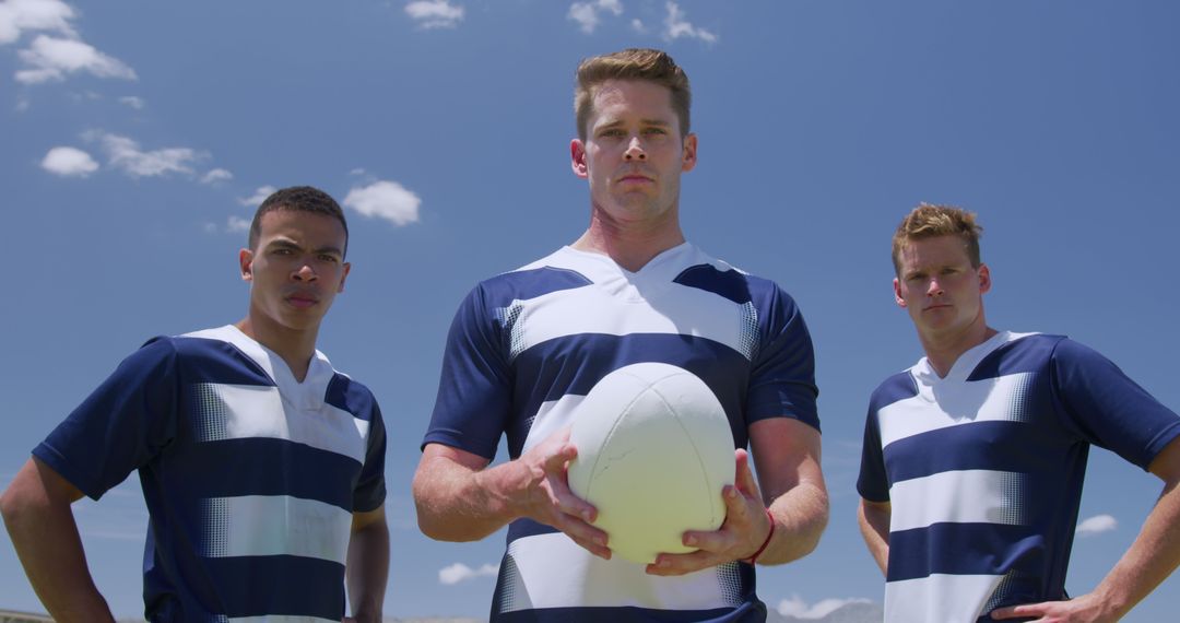 Three Rugby Players Standing Confidently Under Blue Sky, Ready for Game - Free Images, Stock Photos and Pictures on Pikwizard.com