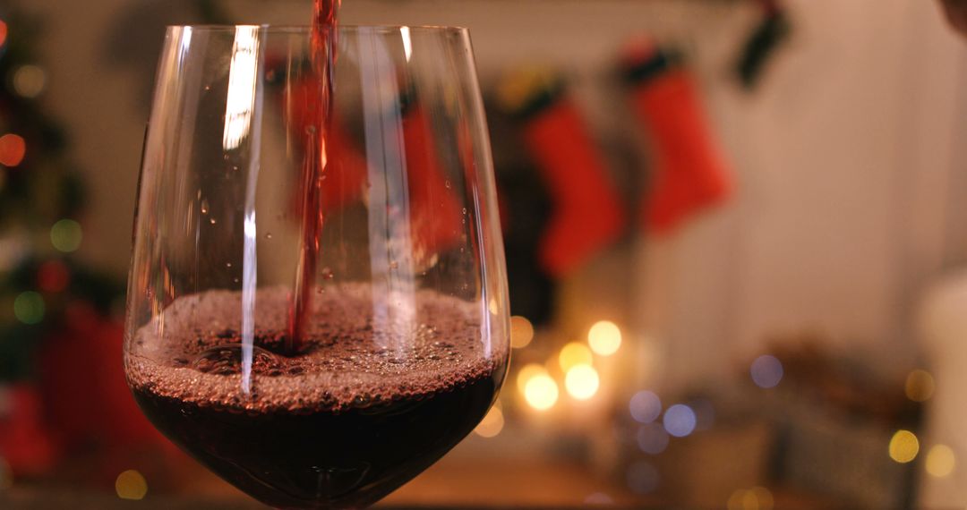 Red wine pouring into glass on wooden table during christmas time 4k - Free Images, Stock Photos and Pictures on Pikwizard.com