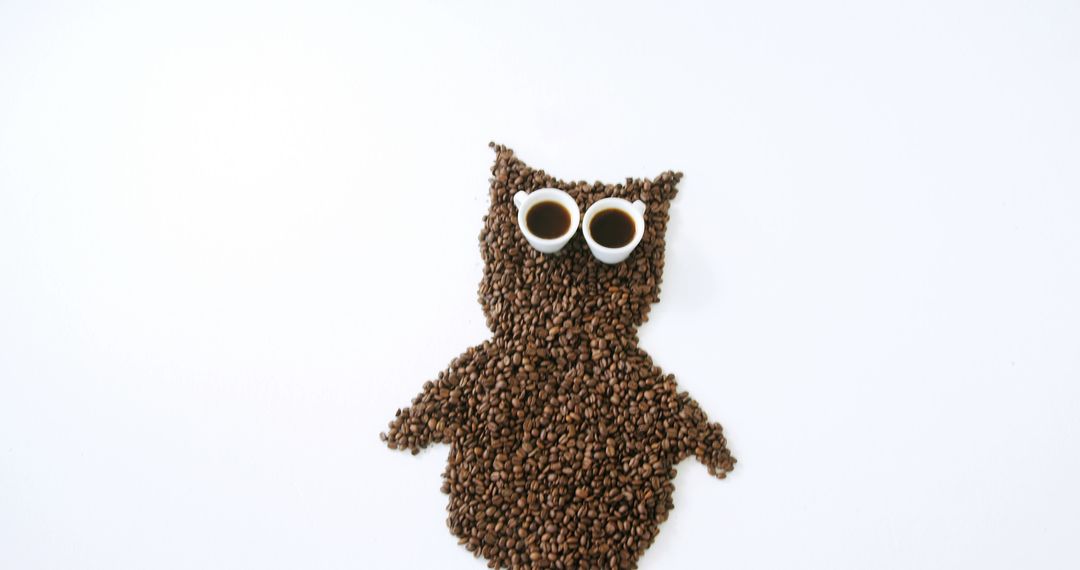 Creative Owl Shape Made from Coffee Beans with Coffee Cups for Eyes - Free Images, Stock Photos and Pictures on Pikwizard.com