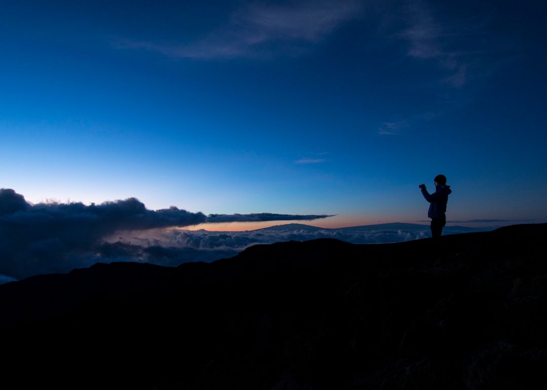 Person Taking Photo at Sunset on Mountain Peak Silhouette - Free Images, Stock Photos and Pictures on Pikwizard.com